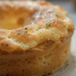 Close-up of a beautifully baked soufflé showing the secret to a good soufflé, with a golden top and airy texture.